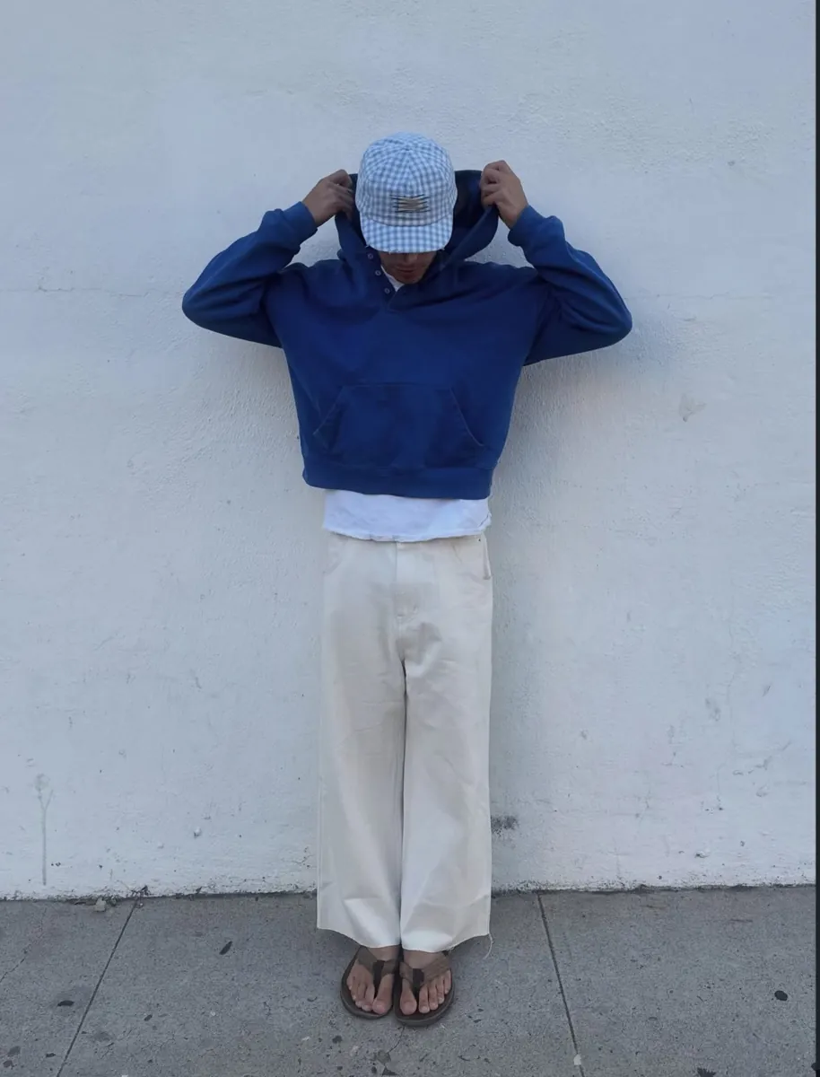 Model in the Soleil Lune Henley Hoodie against a white wall
